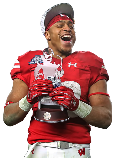 Jonathan Taylor wearing his Wisconsin Badgers Football jersey while holding the Pinstripe Bowl Trophy after winning the game.